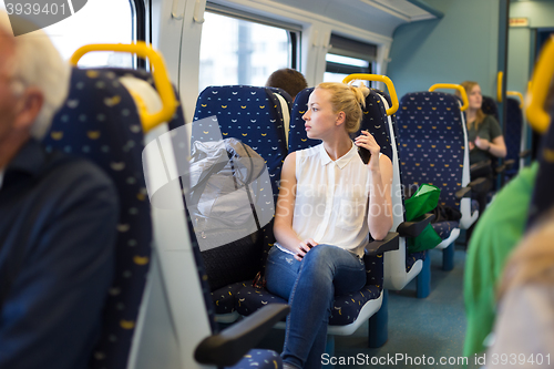 Image of Woman travelling by train.