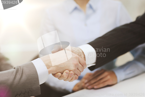 Image of two businessmen shaking hands in office