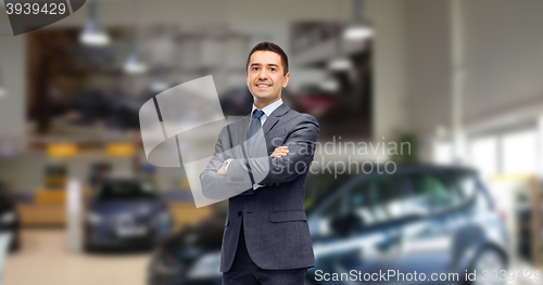 Image of businessman or car dealer over auto show