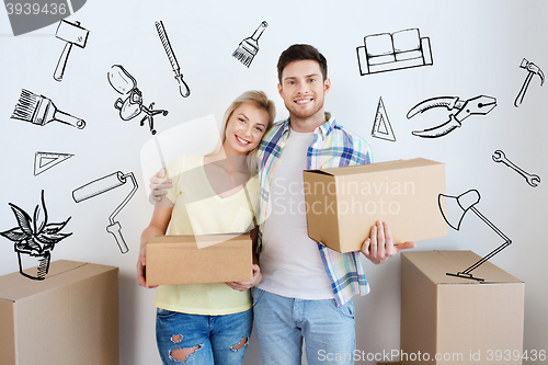 Image of smiling couple with big boxes moving to new home