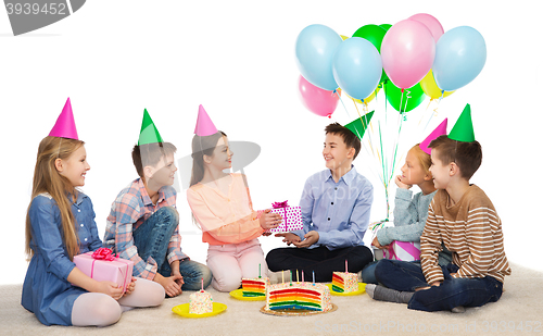 Image of happy children giving presents at birthday party