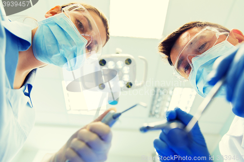 Image of close up of dentist and assistant at dental clinic