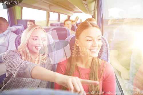 Image of happy young women riding in travel bus