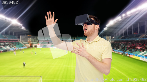 Image of man in virtual reality headset over football field