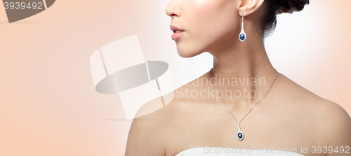 Image of close up of woman with earring and pendant