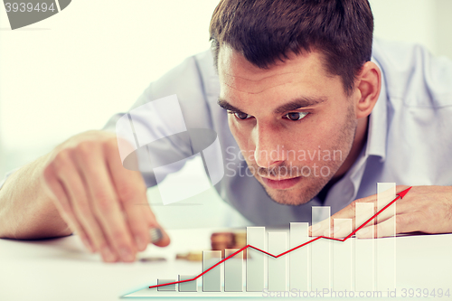 Image of businessman with coins at office