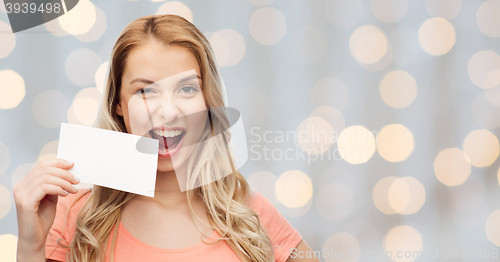 Image of happy woman or teen girl with blank white paper