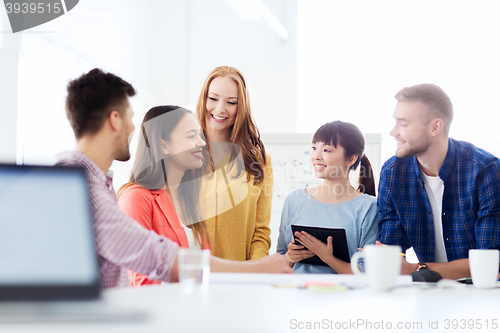 Image of happy creative team or students working at office