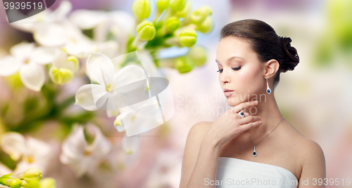 Image of beautiful woman with earring, ring and pendant