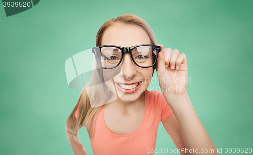 Image of happy young woman or teenage girl in eyeglasses