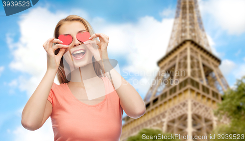 Image of happy young woman with red heart shapes on eyes