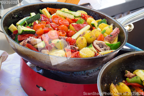 Image of Cheff cooking on outdoor street food festival.