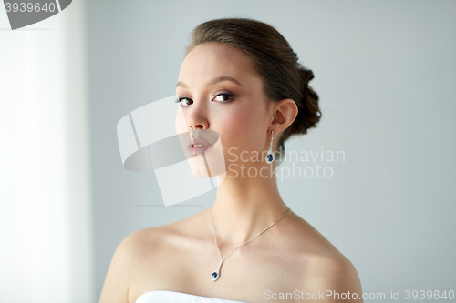 Image of beautiful asian woman with earring and pendant