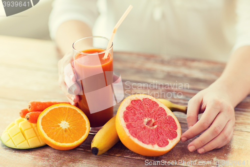 Image of close up of woman hands with juice and fruits