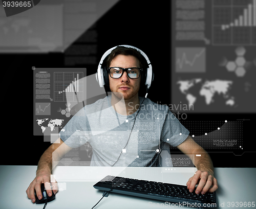 Image of man in headset with computer over virtual screens
