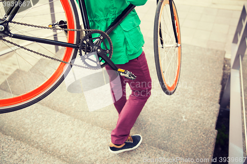 Image of man with fixed gear bike going downstairs