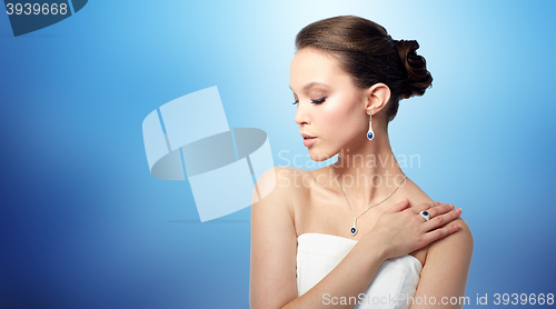 Image of beautiful woman with earring, ring and pendant