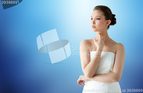 Image of beautiful asian woman with golden bracelet