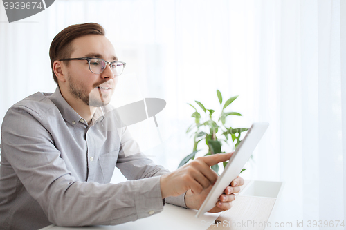 Image of happy creative male office worker with tablet pc