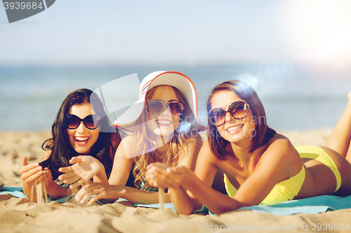 Image of girls sunbathing on the beach