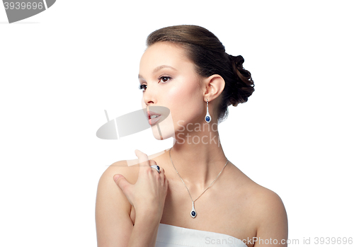 Image of beautiful woman with earring, ring and pendant