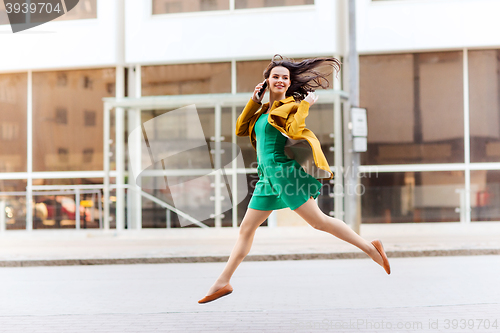 Image of smiling young woman or girl calling on smartphone