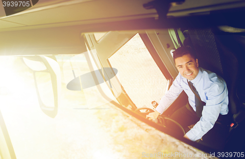 Image of close up of driver reflection in bus mirror