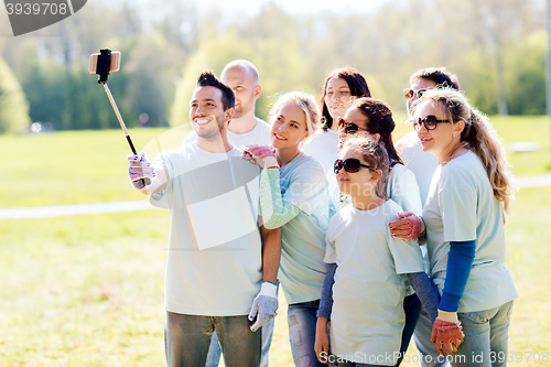 Image of group of volunteers taking smartphone selfie