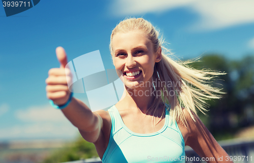 Image of happy young woman exercising outside