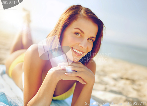 Image of girl sunbathing on the beach