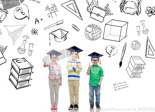 Image of happy children in bachelor hats and eyeglasses