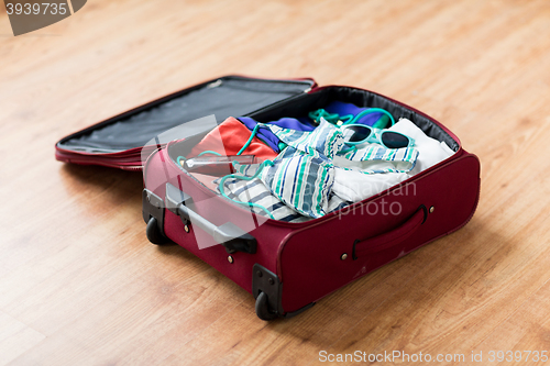 Image of close up of travel bag with beach clothes