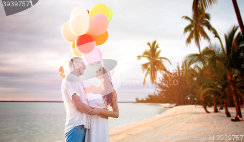 Image of smiling couple with air balloons outdoors