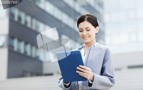 Image of smiling business woman with tablet pc in city