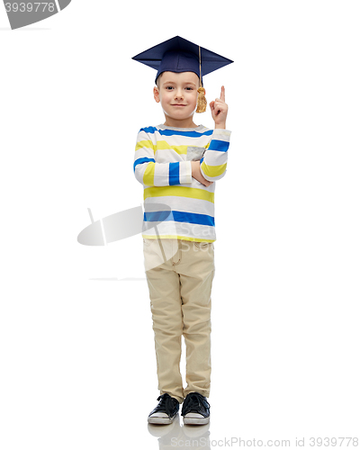 Image of happy boy in bachelor hat pointing finger up