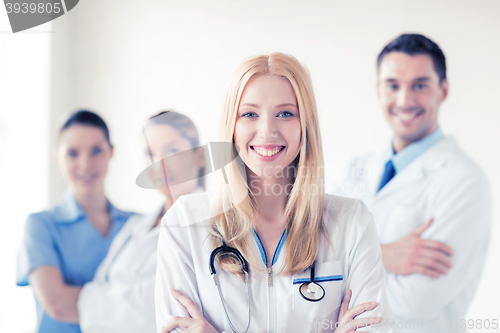 Image of female doctor in front of medical group