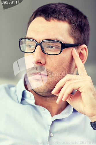 Image of portrait of  businessman in eyeglasses at office