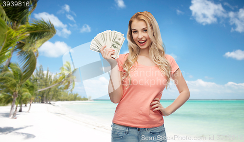Image of happy young woman with usa dollar cash money