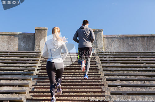 Image of couple running upstairs on stadium