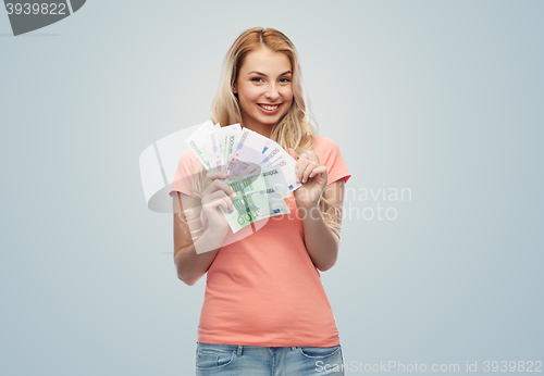 Image of happy young woman with euro cash money