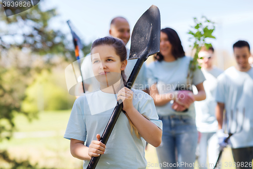 Image of group of volunteers with trees and rake in park