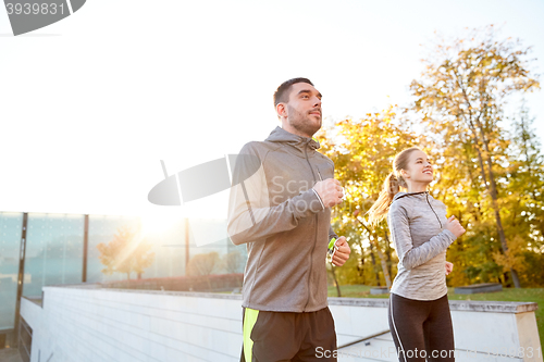 Image of happy couple running upstairs on city stairs