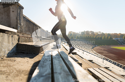 Image of close up of woman running upstairs on stadium