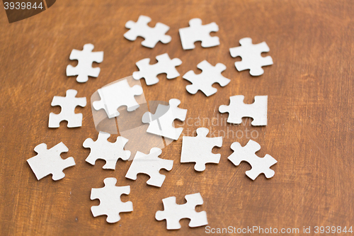 Image of close up of puzzle pieces on wooden surface
