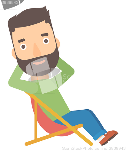 Image of Man sitting in a folding chair.