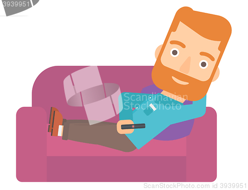 Image of Man sitting on the couch with remote control.