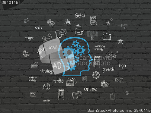 Image of Advertising concept: Head With Gears on wall background