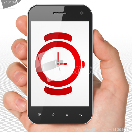 Image of Timeline concept: Hand Holding Smartphone with Hand Watch on display