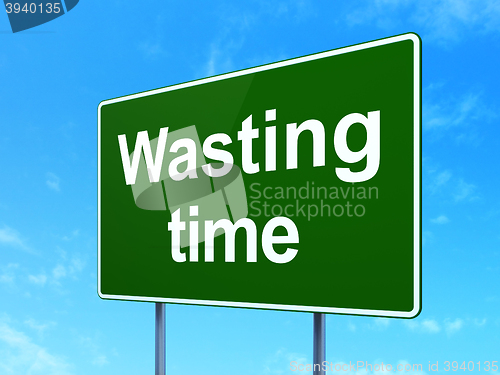 Image of Timeline concept: Wasting Time on road sign background