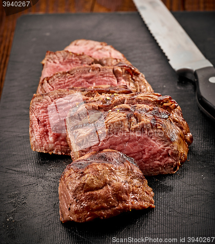 Image of grilled sliced beef steak and knife